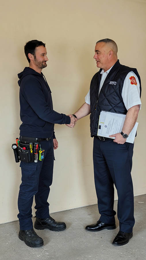 Justin performing a smoke detector inspection